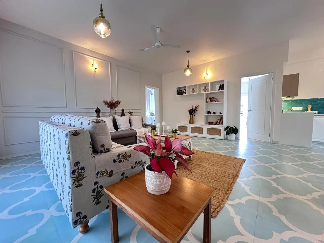 Spacious living room featuring heritage tiled floors, architectural wall panelling, and designer furnishings