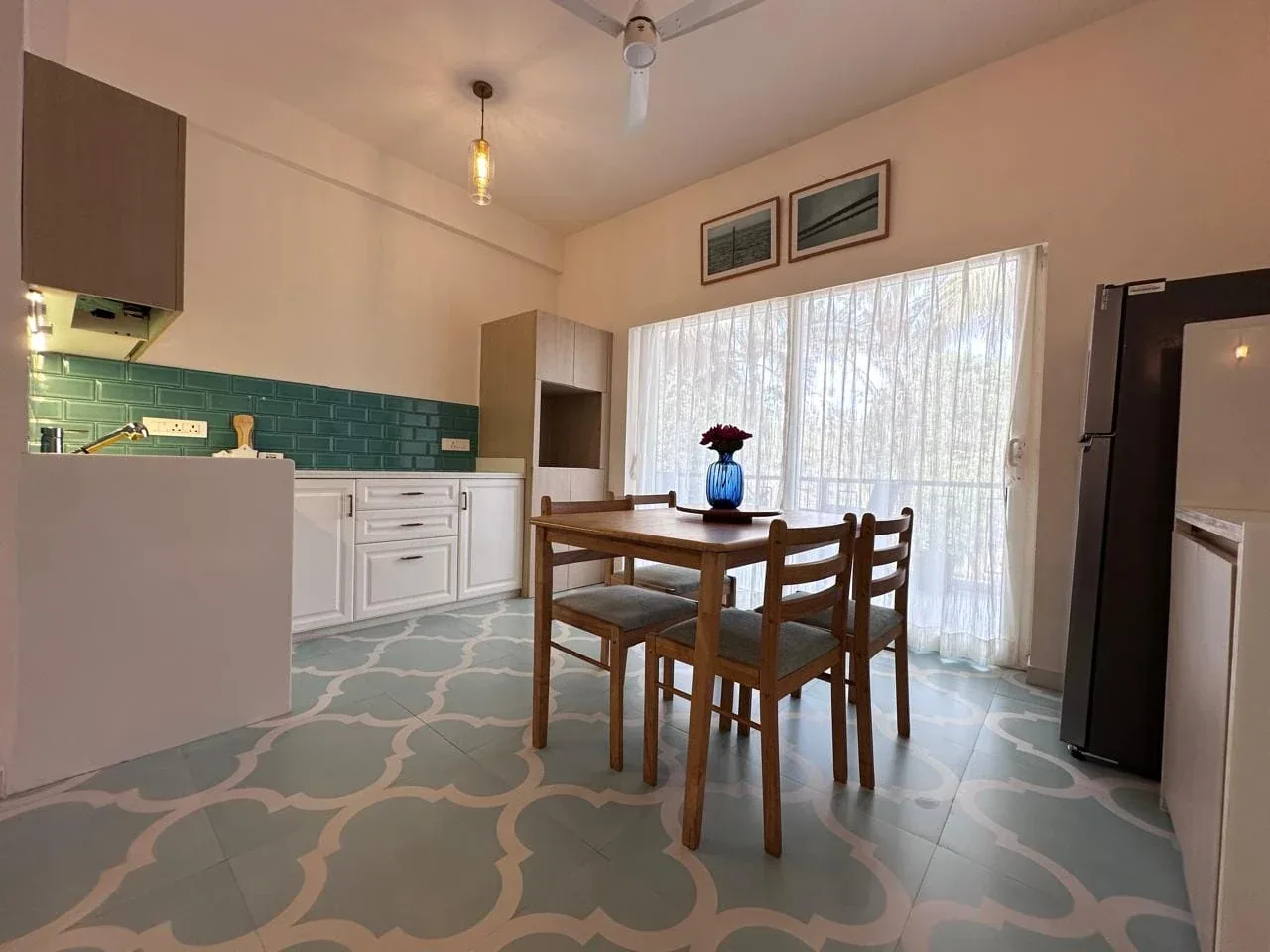 Fully equipped contemporary modular kitchen with subway tile splashback, chimney, and refrigerator