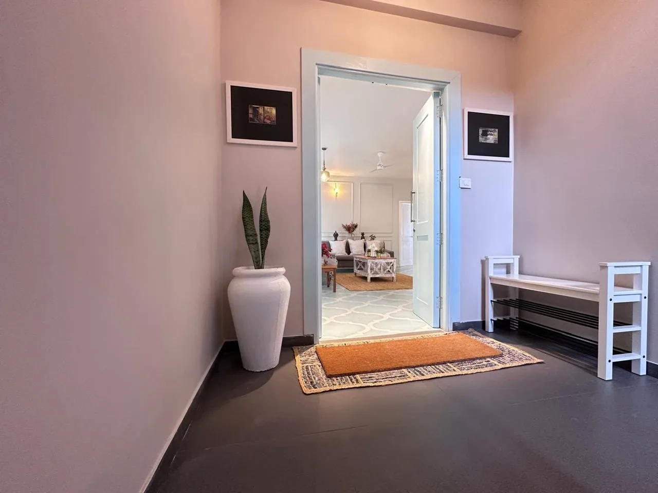 Private entrance foyer with pastel double-leaf entry door and footwear storage bench
