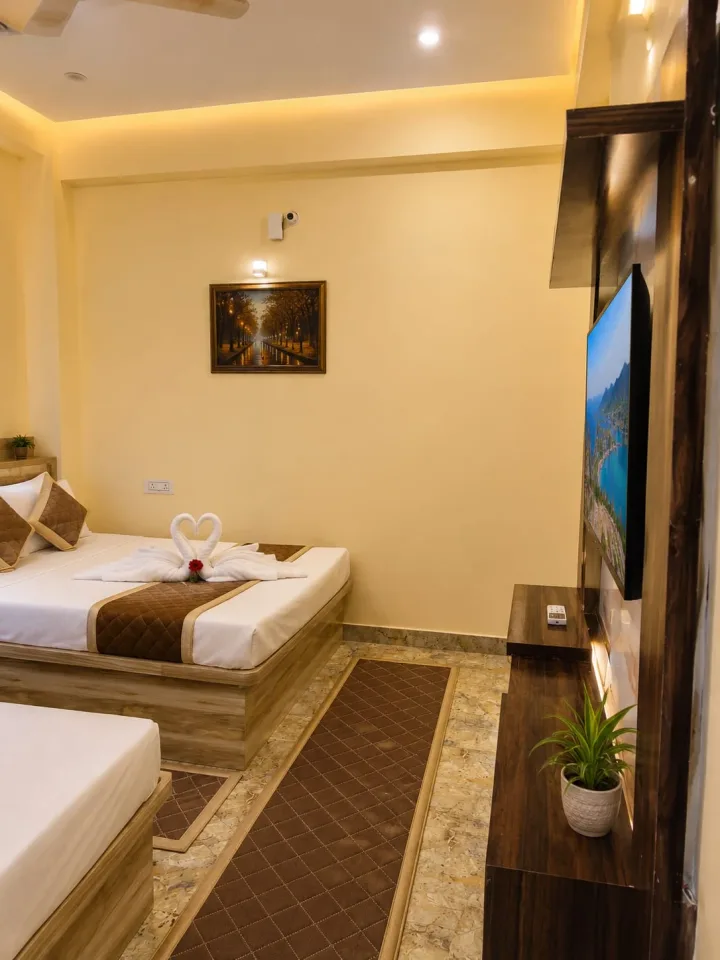 Guest room view showing the wide smart TV wall with fluted wood panelling and bedside runners