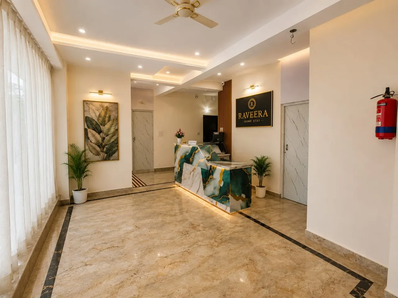 Spacious reception lobby featuring designer marble front desk, illuminated brand signage, and recessed ceiling lighting