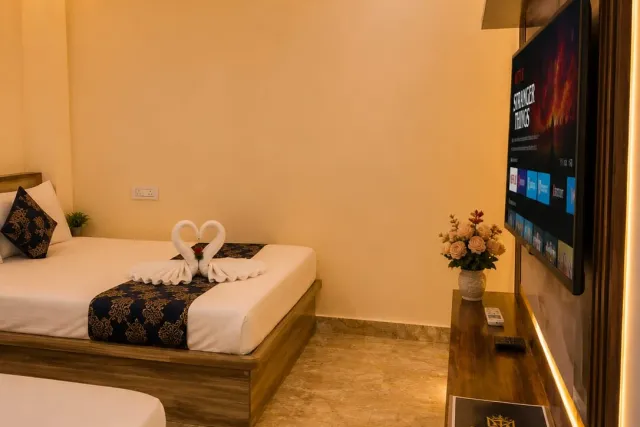 Guest room perspective highlighting the floating smart TV console with ambient LED cove lighting and guest directory