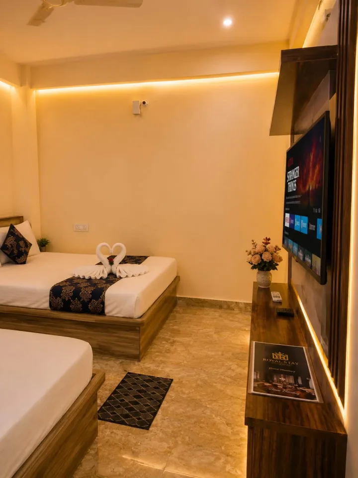 Guest room perspective highlighting the floating smart TV console with ambient LED cove lighting and guest directory