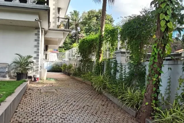Paved driveway approach and landscaped grounds