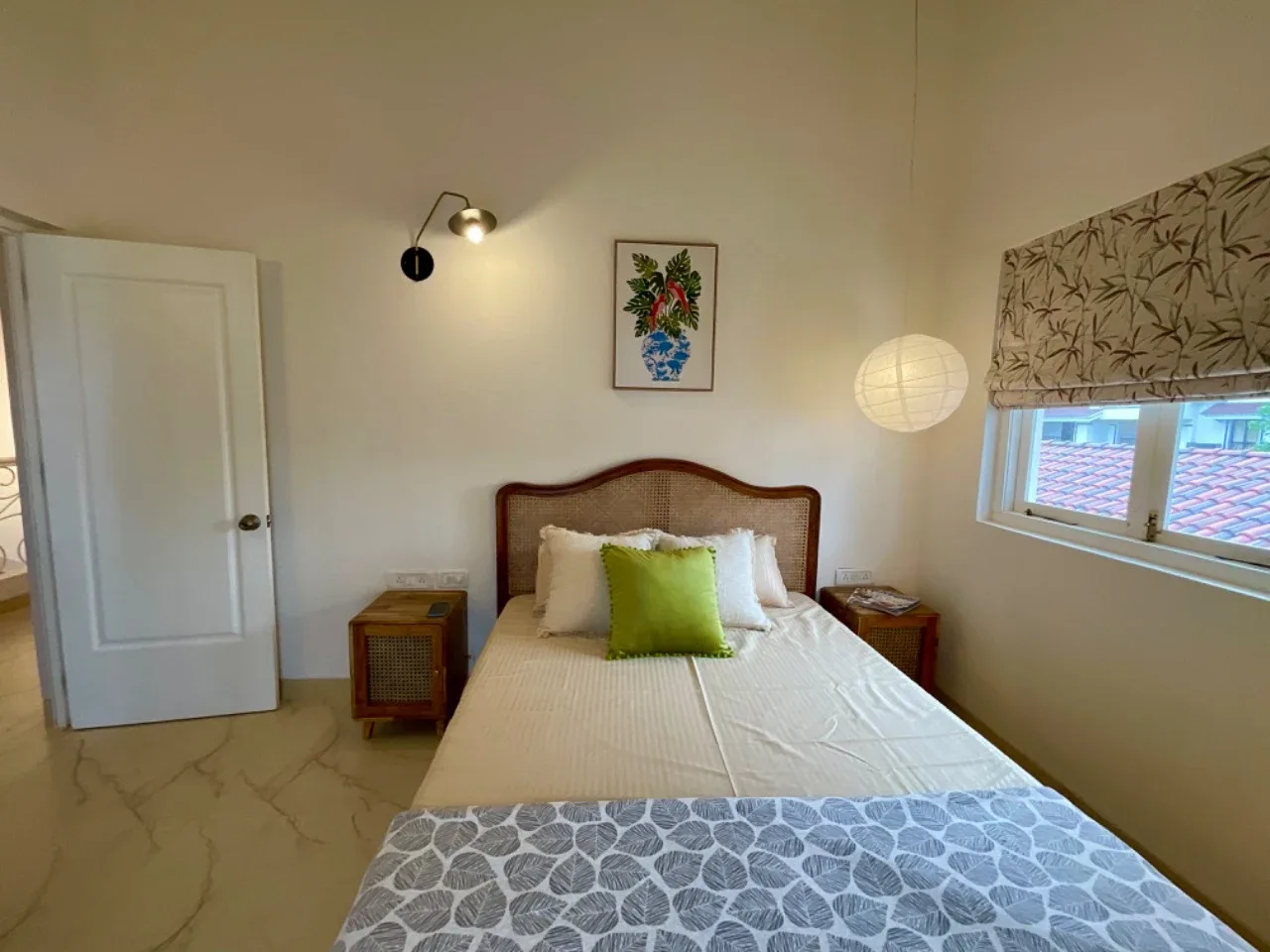 Bedside vista of second bedroom showcasing warm globe pendant lighting and window blind