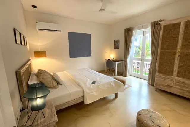 Ground-floor bedroom with French doors opening towards the landscaped grounds