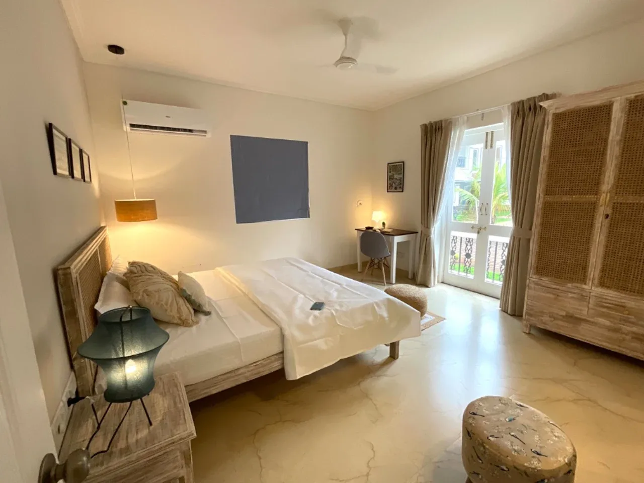Ground-floor bedroom with French doors opening towards the landscaped grounds